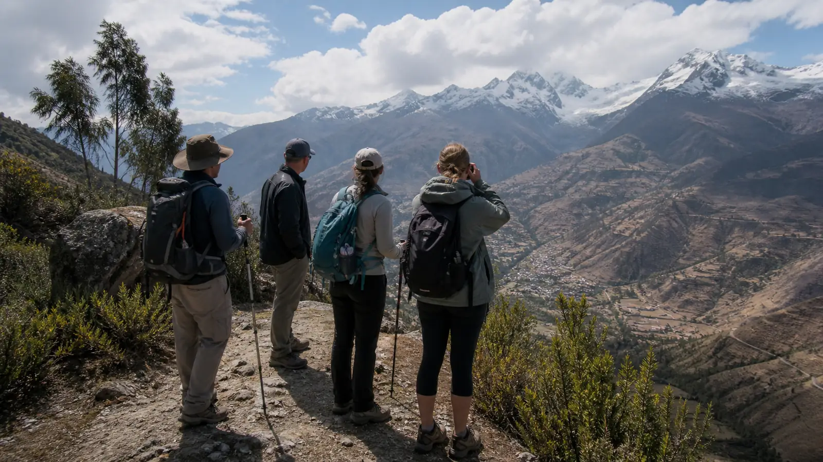 Hikers pausing during a gradual acclimatization walk above Huaraz with Andean peaks in the distance