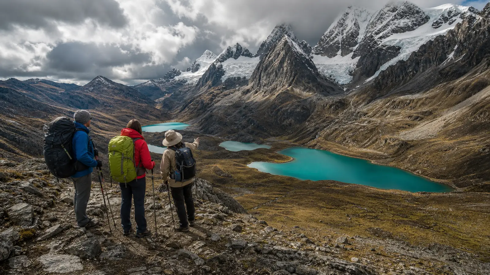 Hikers viewing the turquoise glacial lakes along the Carhuacocha to Siula stage of the Huayhuash Trek